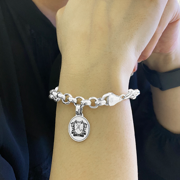 Sterling silver thick beacelet with family crest pendant.