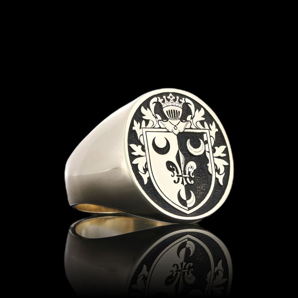 Gold signet ring with the Kenney family crest, a symbol of tradition and timeless style.