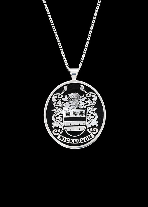 Silver pendant engraved with family crest and the name 'Nickerson,' suspended on a delicate silver chain.