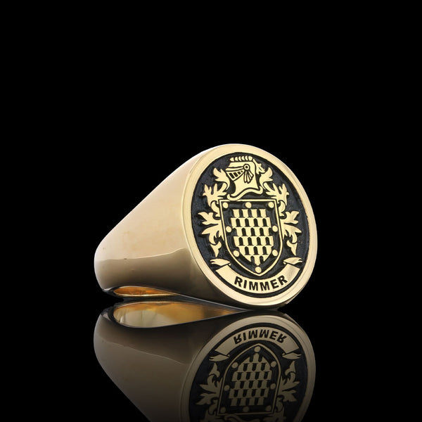 Rimmer family gold signet ring with a checkered crest, displayed with a regal and polished finish.