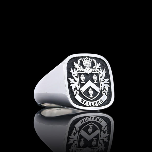 Elegant silver ring with the Sellers family coat of arms, framed by intricate engraving.