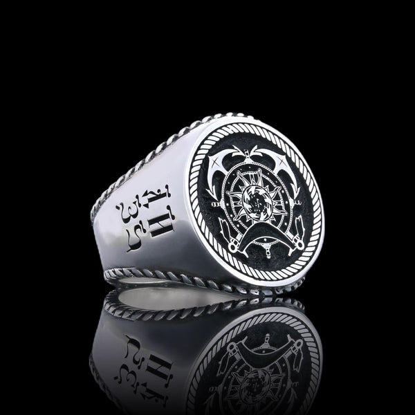 Intricately crafted silver signet ring with nautical motifs and a bold crest.