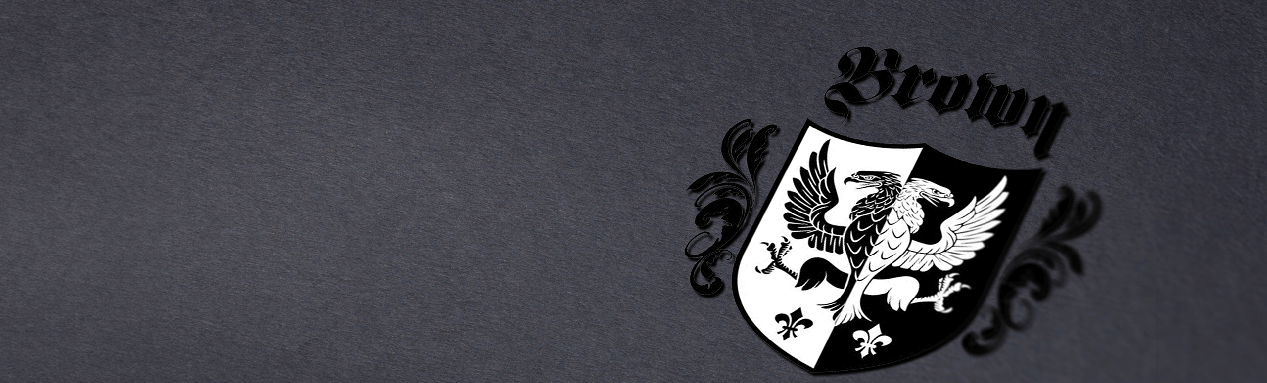 Brown family crest on a dark gray background, featuring a black and white eagle design on a divided shield.